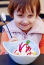 Beautiful little child girl eating ice cream  in the summer food, dessert, childhood, satisfaction, carelessness concept Royalty Free Stock Photo