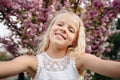 Beautiful little child girl with sakura flowers Royalty Free Stock Photo