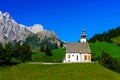 Beautiful little church in Alps. Sunny day, green grass on the h Royalty Free Stock Photo