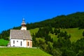 Beautiful little church in Alps. Sunny day, green grass on the h Royalty Free Stock Photo