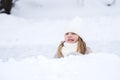 Beautiful little cute girl learn to skate on ice skating rink in park. Fall down and have fun. Stylish look, warm woolen coat, Royalty Free Stock Photo