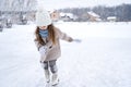 Beautiful little cute girl learn to skate on ice skating rink in park. Fall down and have fun. Stylish look, warm woolen coat, Royalty Free Stock Photo