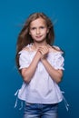 Beautiful little fashion model on white background. Portrait of cute smiling girl posing in studio. Royalty Free Stock Photo