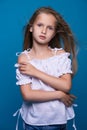 Beautiful little fashion model on white background. Portrait of cute smiling girl posing in studio. Royalty Free Stock Photo