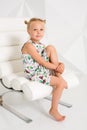 Beautiful little fashion model on white studio background. Portrait of cute girl posing in studio Royalty Free Stock Photo