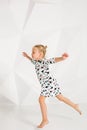 Beautiful little fashion model on white studio background. Portrait of cute girl posing in studio Royalty Free Stock Photo