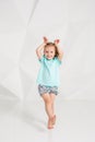 Beautiful little fashion model on white studio background. Portrait of cute girl posing in studio Royalty Free Stock Photo