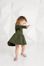 Beautiful little fashion model on white studio background. Portrait of cute girl posing in studio Royalty Free Stock Photo