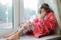 Beautiful little girl in bathrobe with cup of tea Royalty Free Stock Photo