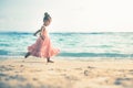 Beautiful little girl at the beach. Sunblock cream for children.