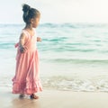 Beautiful little girl at the beach. Sunblock cream for children.