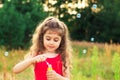 Beautiful Little Girl blowing soap bubbles at the field at summer day - happy childhood concept Royalty Free Stock Photo