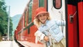 Beautiful little girl boarding the old red train at the railway station Royalty Free Stock Photo