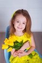 Beautiful little girl with a bouquet of tulips. Spring and summer portrait of cute child holding flowers. Royalty Free Stock Photo