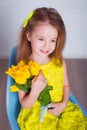 Beautiful little girl with a bouquet of tulips. Spring and summer portrait of cute child holding flowers. Royalty Free Stock Photo