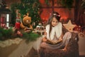 Beautiful little girl brunette read Christmas stories to her toy teddy bear. Royalty Free Stock Photo