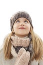Beautiful little girl in cap and scarf looking up. Winter style Royalty Free Stock Photo