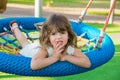 Beautiful little girl on children`s swing Royalty Free Stock Photo