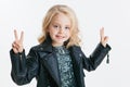 Beautiful little girl with curly blonde hairstyle on the holiday party in dress with sequins and black jacket. Silver Royalty Free Stock Photo