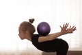 Beautiful little girl doing exercises with a fitness ball. Sport and healthy lifestyle concept. Royalty Free Stock Photo