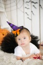 Beautiful little girl with Down syndrome in a suit a little witch