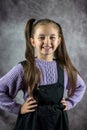 beautiful little girl in dress standing and posing isolated over plain background. Royalty Free Stock Photo