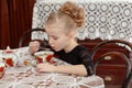 Beautiful little girl drinking tea at the table. Royalty Free Stock Photo