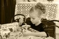 Beautiful little girl drinking tea at the table. Royalty Free Stock Photo