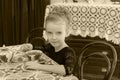 Beautiful little girl drinking tea at the table. Royalty Free Stock Photo