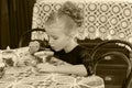 Beautiful little girl drinking tea at the table. Royalty Free Stock Photo