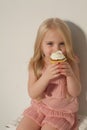Beautiful little girl eating sweet candy lollipop cake Royalty Free Stock Photo