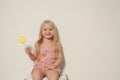 Beautiful little girl eating sweet candy lollipop cake Royalty Free Stock Photo