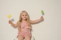 Beautiful little girl eating sweet candy lollipop cake Royalty Free Stock Photo