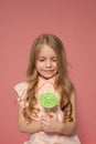 Beautiful little girl eating sweet candy lollipop cake Royalty Free Stock Photo