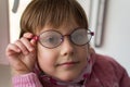 Beautiful little girl with fogged eyeglasses Royalty Free Stock Photo