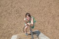 Beautiful little girl with funny face expressions playing, climbing up on a wooden stairs Royalty Free Stock Photo