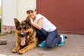 beautiful little girl with a german shepherd playing on the lawn at the day time Royalty Free Stock Photo