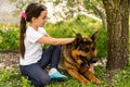 beautiful little girl with a german shepherd playing on the lawn at the day time Royalty Free Stock Photo