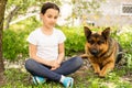 beautiful little girl with a german shepherd playing on the lawn at the day time Royalty Free Stock Photo