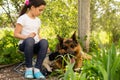 beautiful little girl with a german shepherd playing on the lawn at the day time Royalty Free Stock Photo