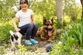 beautiful little girl with a german shepherd playing on the lawn at the day time Royalty Free Stock Photo