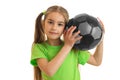 Beautiful little girl with grey soccer ball in her hands looks at the camera Royalty Free Stock Photo