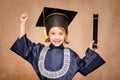 Beautiful little girl happy with her graduation. Dressed with her graduation cap and diploma in hand Royalty Free Stock Photo