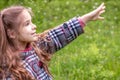 Beautiful little girl has fun outdoors in spring park with dandelion flower. Happy child. Royalty Free Stock Photo