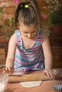 Beautiful little girl having fun cooking