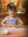 Beautiful little girl having fun cooking