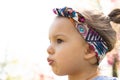 Beautiful little girl with headband in spring day in the park. Close up view Royalty Free Stock Photo