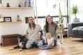 Beautiful little girl and her parent getting some puppy love on the living room