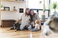 Beautiful little girl and her parent getting some puppy love on the living room