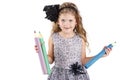 Beautiful little girl holding big crayons Royalty Free Stock Photo